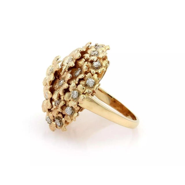 This is a magnificent diamond floral cluster Estate ring. It is crafted from solid 18k yellow gold with the band in a fine...