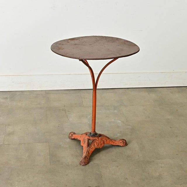 Dimensions: 28” H x 21 ½” W x 21 ½” D A French turn of the century (circa 1900) cast iron round bistro table with...