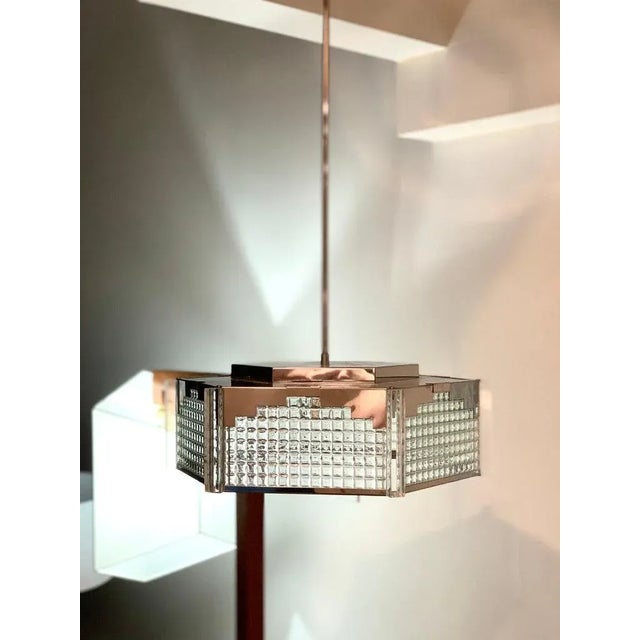 Chromed steel, art glass and Lucite Postmodern pendant fixtureby Fredrick Ramond. Neo-Deco, inspired by the streamline...