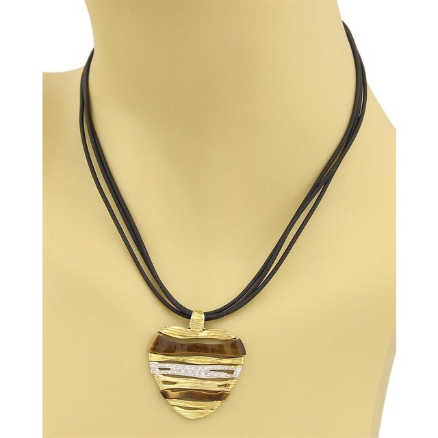 This authentic pendant and triple cord neckace is by designer Roberto Coin from his Elephant Skin Collection. The pendant...