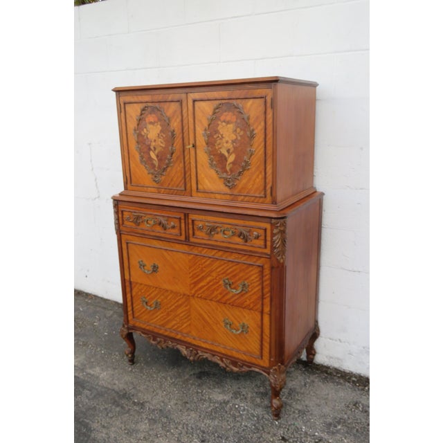 This classic Chest of Drawers is made out of wood, solid wood, mix wood, veneer, and brass. it was made by Johnson...