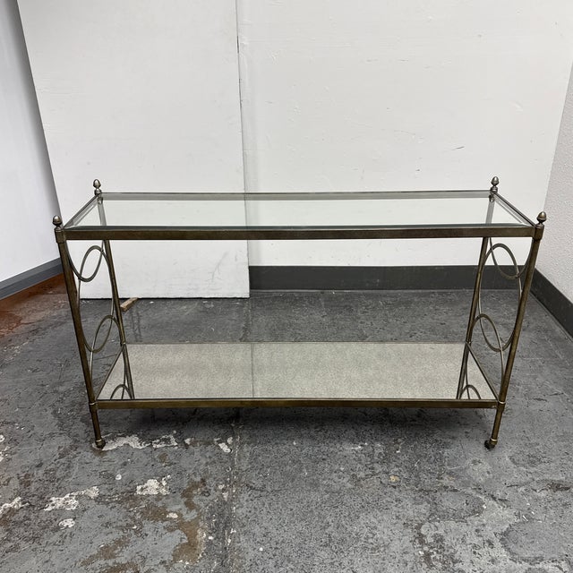 Design Plus Gallery presents a Vintage Hollywood Regency Metal + Glass Console Table. This late 20th-century console is...