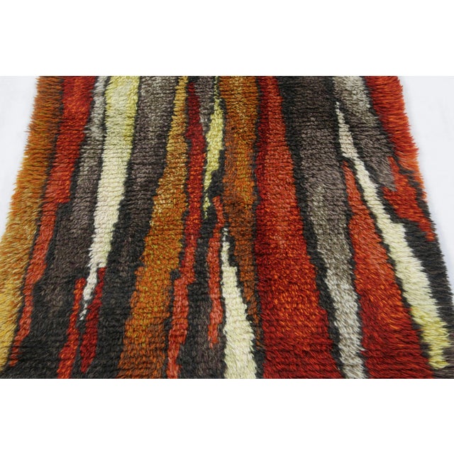 Hand-knotted in lush, high-pile wool in Sweden circa 1960-1970, this 3x5 vintage Swedish Rya rug is a bold new addition to...