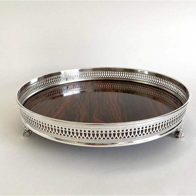 This Sheffield silver plate rimmed tray with a Formica surface represents the mid-century modern period when products...