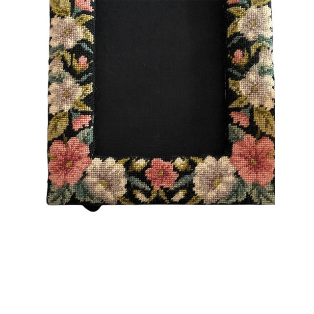 Standing easel needlepoint picture frame. Pink and cream flowers on a black ground with a black felt backing. Excellent...