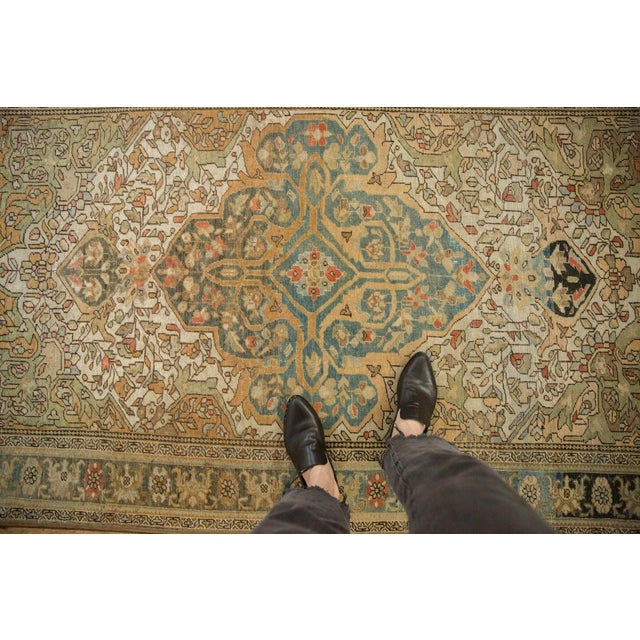 :: Shield-like oversized center medallion adorned by double tiered finial ends atop a covered blossom and vine main field....