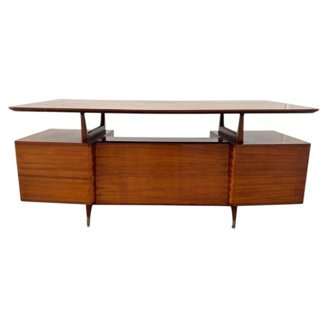 This elegant mid-century Italian desk stands out for its warm, fine dark wood finish, lending it a sophisticated and...