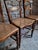 Set of four antique dining chairs dating from around 1900–1920. The chairs are made of solid beech and feature woven cane...