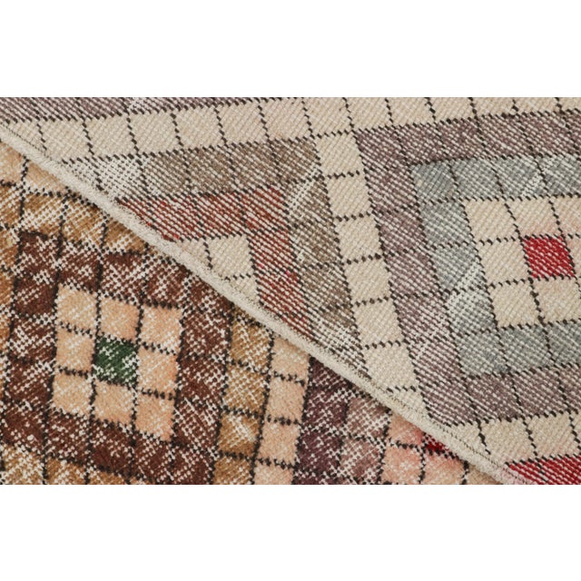 Made with hand-knotted wool circa 1950-1960, this 5x9 vintage Turkish rug of all over diamond medallion design is an...