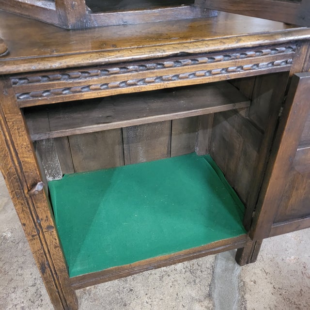 This handsome Small English Gothic Revival Oak Court Cupboard is adorned with carving and a pair of turned columns. It has...
