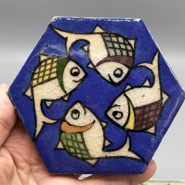 Set of 3 vintage Persian tiles possibly dating back to the Qajar dynasty (1789-1925). Each tile features a swimming fish...