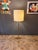 Floor lamp made of brass and enameled metal. The lamp has 3 lights with E27 screw fittings. Original and functioning...