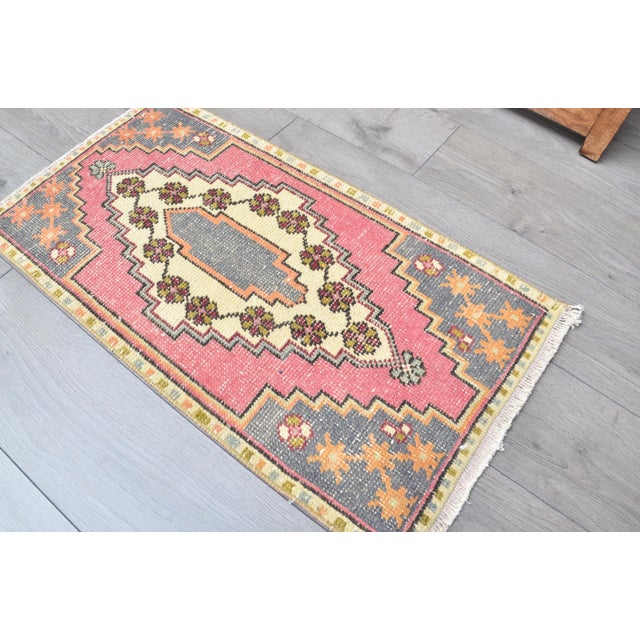 This is a vintage Turkish Oushak rug from the 1960s. The piece was hand-knotted.