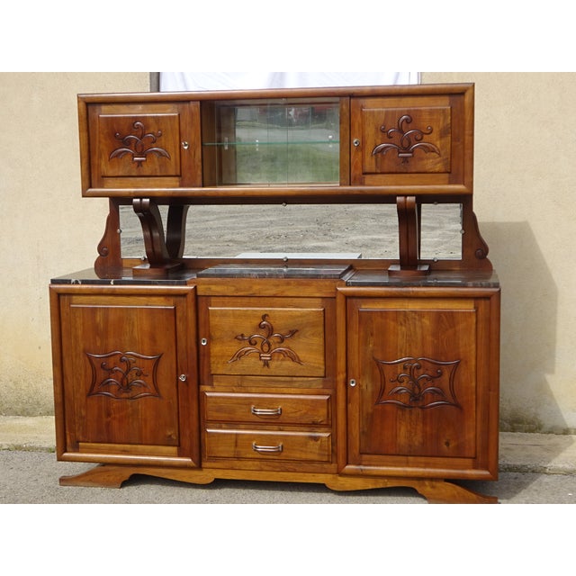 Large and beautiful solid walnut sideboard with mustache-shaped legs and simple, straight curves. Lower section: pyramidal...