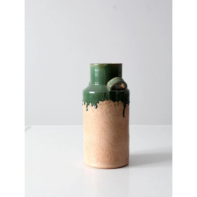A vintage Italian terra cotta vase featuring a sculptural double-handled form and a bold, architectural block neck. The...