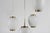 Set of four China pendents made of off-white opaline glass and with brass fittings. The pendants are designed by Danish...