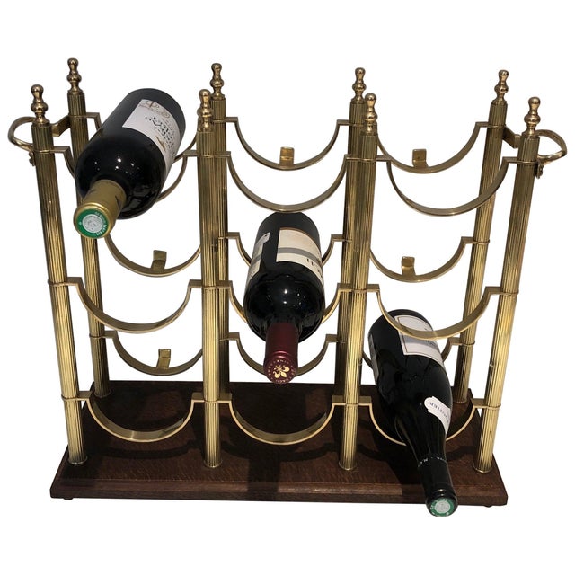 This beautiful neoclassical-style bottle rack is made of brass on a wooden base. It is a French work in the style of...