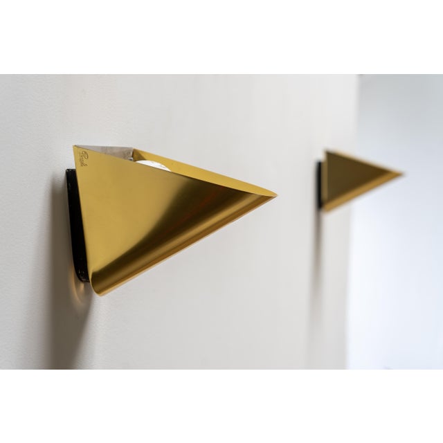 Elegant and rare pair of brass wall sconces by Jean Perzel. Designed and crafted in France, these timeless pieces embody...