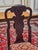 An elegant set of four dining chairs in the style of Thomas Chippendale, made in England in the first half of the 20th...