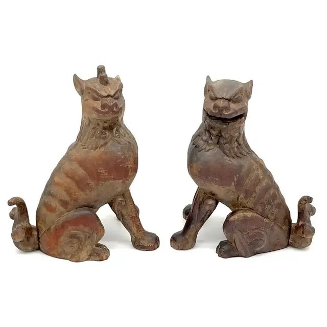 A unique and enchanting pair of 19th Century Tibetan carved wood & polychromed foo/guardian/temple dogs. These mythical...