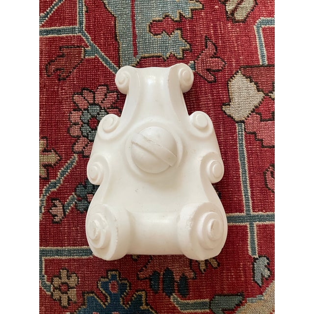 This carved marble keystone is to and antique fire mantle. It has lovely scrollwork and curves. This could be a marvelous...