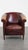 Offered this charming English-style cowhide leather club chair with a fixed seat cushion and a beautiful patina. This...