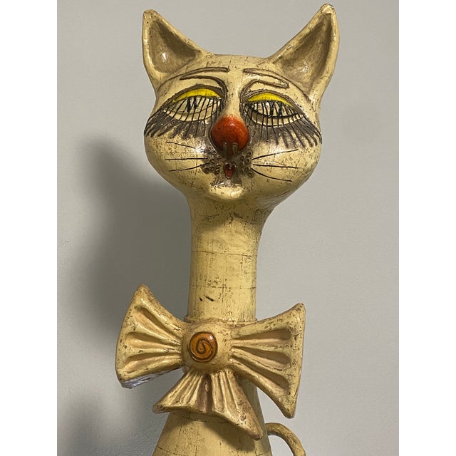 Whimsical oversized seated cat sculpture by Jeanne Valentine, handmade in Mexico from papier-mâché. The piece features an...