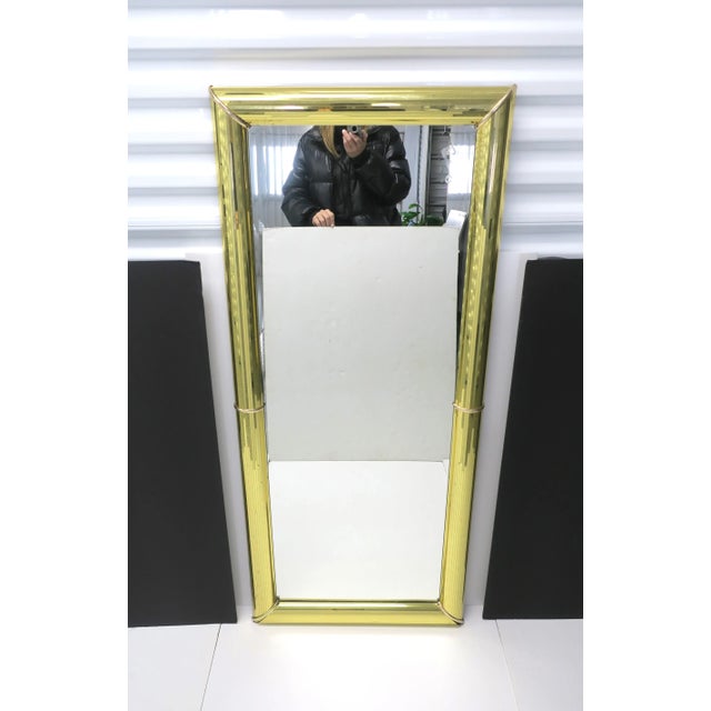 A gold '70s Modern Disco style full length wall or floor mirror, Postmodern period, 1985, USA. Mirror has a gold 'Disco'...