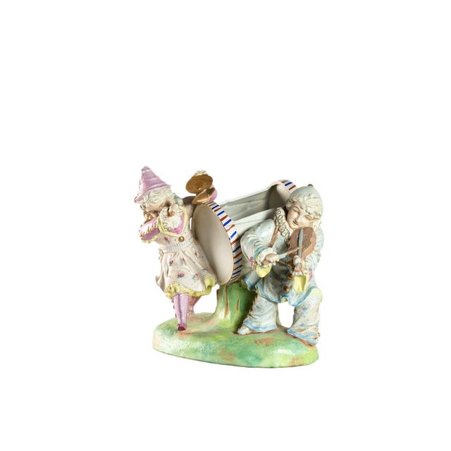 A saxony art piece, large polychrome porcelain of a figurine of a male violinist and a women's percussionist musicians...