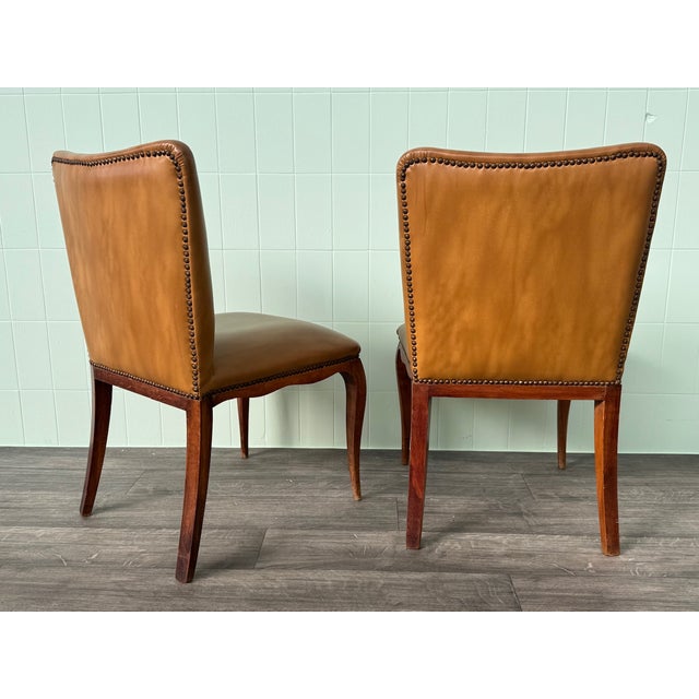 These vintage armchairs feature a style reminiscent of Louis XV design, featuring a wooden frame with sinuous legs and...