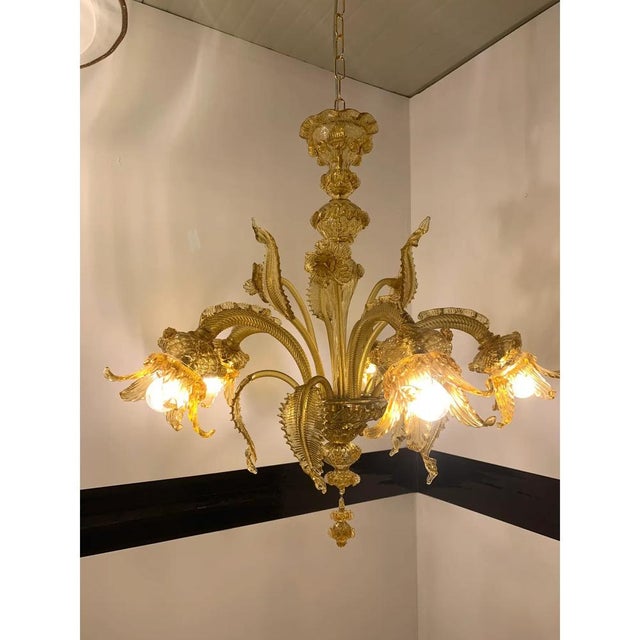 Classical amber Murano glass chandelier with flowers and leaves. Traditional piece of Italian art of blowing glass. Very...