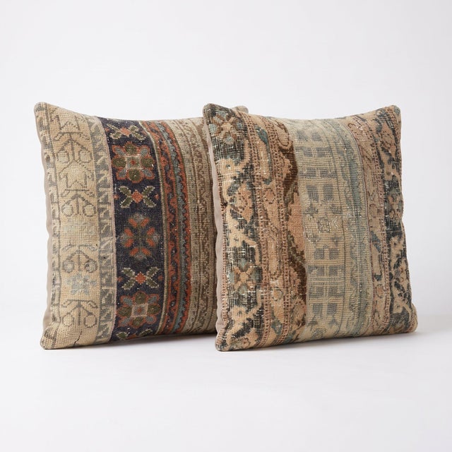 This 24'' x 24'' pillow cover set was made from authentic Turkish rug pieces — striped Oushak bands in tan, navy and rust....