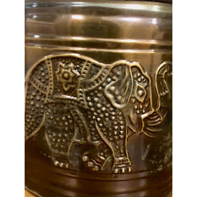 If you love elephants, you're going to love this brass cache pot planter that has embossed elephants circling the...