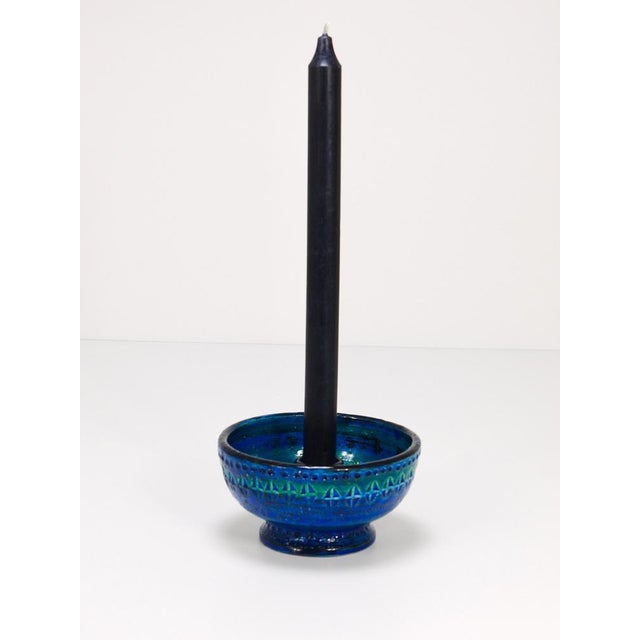 A beautiful and decorative midcentury Rimini blue glazed round candle holder or candlestick. Designed by Aldo Londi,...