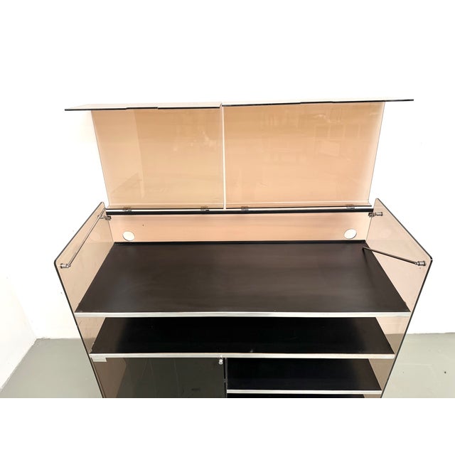 Maison lecan presents this hi-fi cabinet in smoked acrylic glass and brushed aluminum, attributed to eric maville, france,...