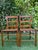 A pair of vintage ladder back dining chairs featuring warm wood frames and handwoven basketweave rattan seats. Clean...