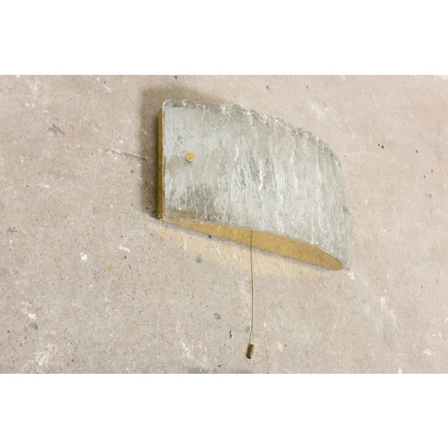 Beautiful brass pair of large 1950s glass sconces or wall lamps by Kaiser Leuchten, Germany. Thick textured glass creates...