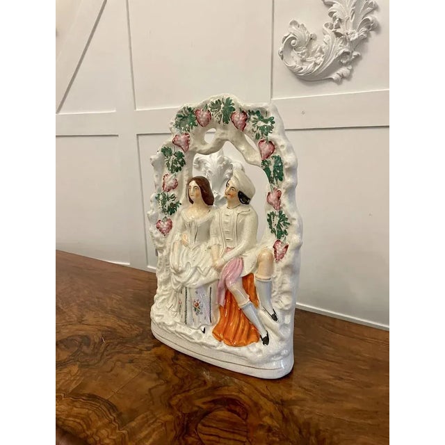 Antique 19th century antique staffordshire flatback of a wedded couple seated under grape vines dressed in period wedding...