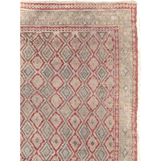 This mid-20th-century Turkish Anatolian small runner presents an ordered allover lattice of narrow diamond forms set...