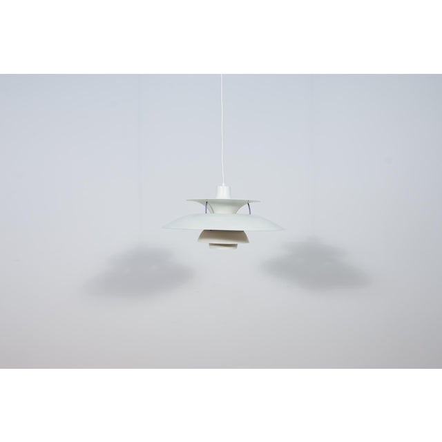 This is a Poul Henningsen's 1958 design based on the principle of a reflective three-shade system, which directs the...