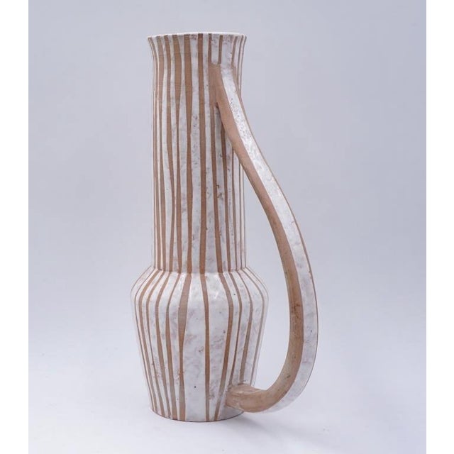 Vintage mid 20th century tall pottery pitcher by Joel Edwards (1923 - 2007) California. Signed on bottom, tan bisque with...