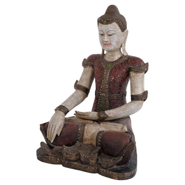 Decorative Buddha figure carved in wood with beautiful reddish-brown tones. Originating from Thailand and dating to the...