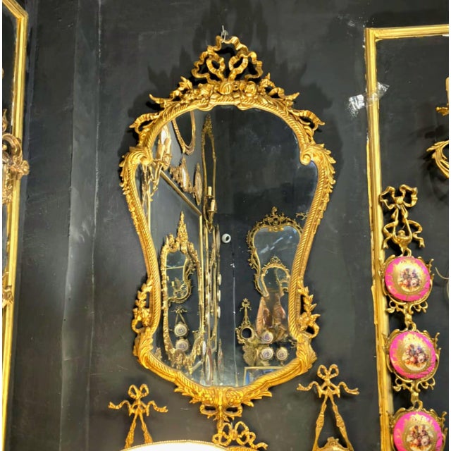 This elegant French Baroque style wall mirror features a richly detailed gold leaf frame with beautifully hand-carved...
