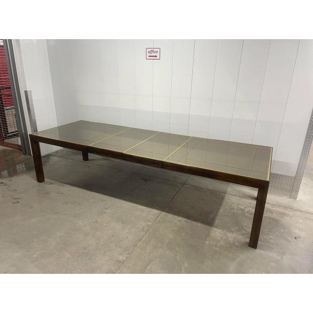 This vintage parsons dining table is part of the 'Scene Two Collection' by Henredon and features an etched glass smoked...