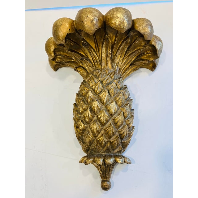 This pair of cast polymer pineapples has a gold tone finish The Palm Beach Regency style is embellished with a quality...