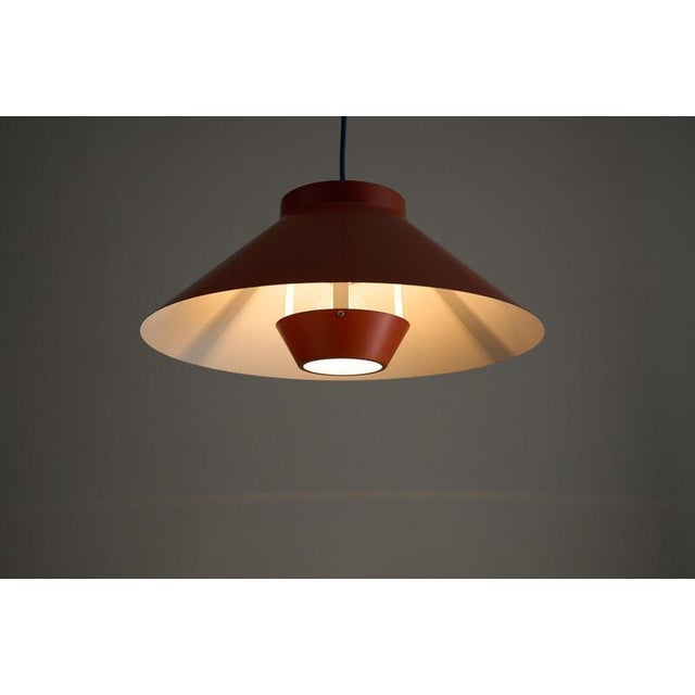 Sleek pendant light dates from the 1970s, that embodies the functional elegance of Scandinavian Modern design. The fixture...
