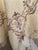 An exquisite hand-embroidered trousseau linen set comprising a large 60×80" tablecloth and 12 matching napkins, each...