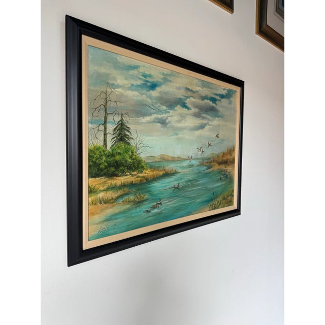 A serene 1979 vintage oil painting on canvas signed Little, depicting a peaceful marshland scene with ducks gliding and...
