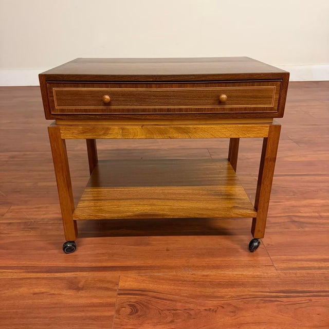 Vintage mid-century modern rolling side table with a single drawer and lower shelf. A versatile piece that works...