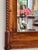 A 19th century Biedermeier birch mirror, the shaped crest over a figured birch panel with an inlaid line border, rope-...